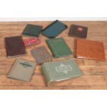 A collection of antique and other empty postcard albums.