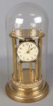 An ornate Badische Uhrenfabrik gilt mantel clock under glass dome. (45cm)