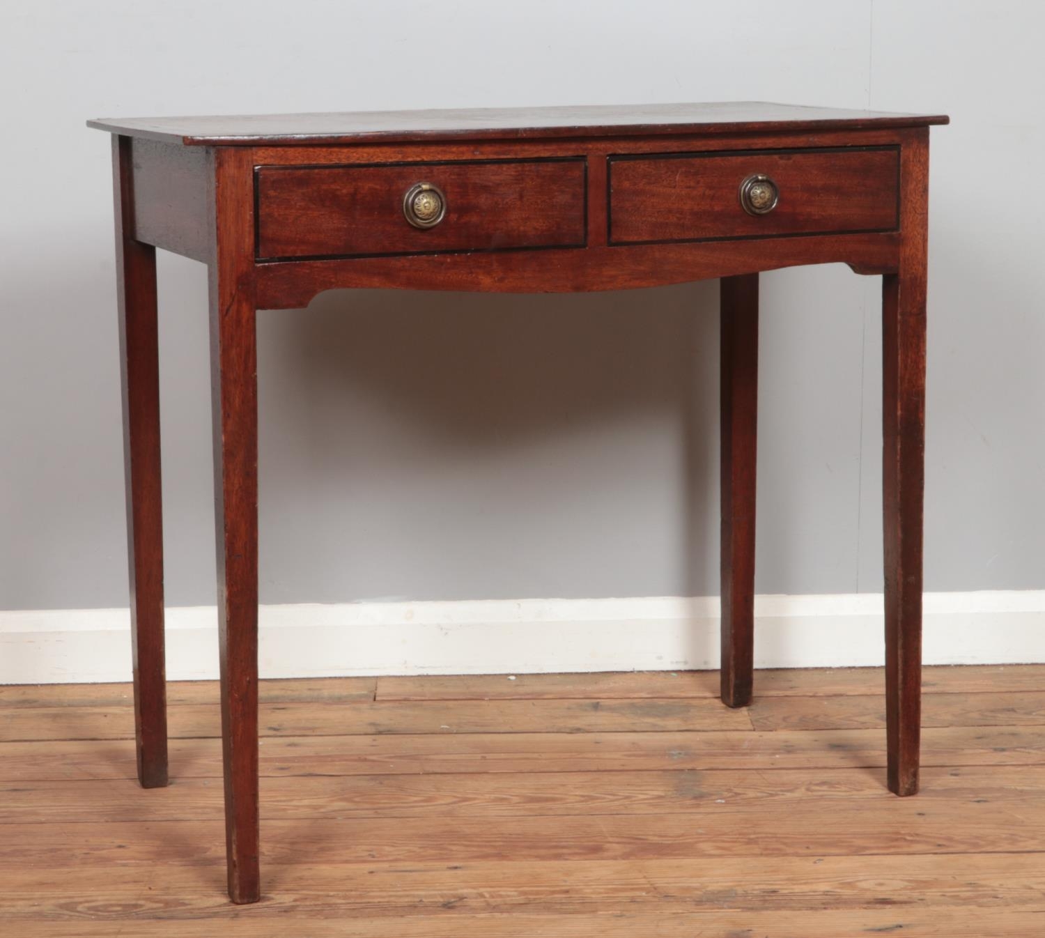 A Georgian Mahogany side table having two short drawers with brass ring pull handles. Hx75cm