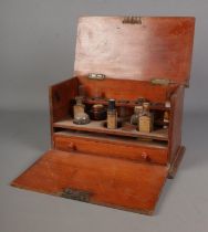 An early 20th century mahogany apothecary cabinet with singular draw under two fitted shelves,