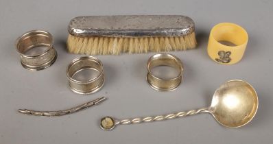 A collection of silver to include napkin rings, spoon, brush, etc. Approx. silver only weight 70g.