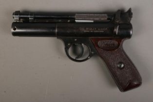 A Webley "Senior" 0.22 cal air pistol featuring chequered grips. CANNOT POST OVERSEAS.