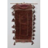 An antique Eastern saddle bag rug, with frilled and tasseled edge. Length: 112cm, Width: 55cm