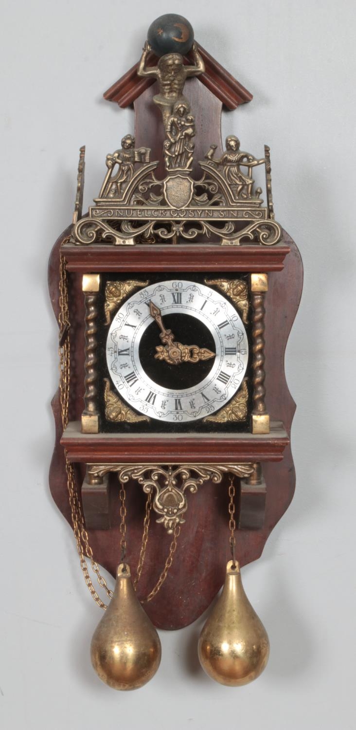 A Dutch brass and oak mounted wall clock, 20th century, the silvered dial with black Roman