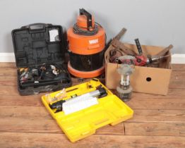 A collection of power tools including Mac Hammer drill, Laser tool, Vas hoover and other tools