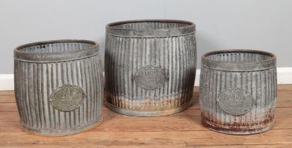 Three dolly tub style 'Jardin & Fleurs' metal garden planters.