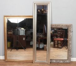 Three mirrors, including two beveled edge examples. Gilt example 132cm x 103cm.