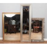 Three mirrors, including two beveled edge examples. Gilt example 132cm x 103cm.