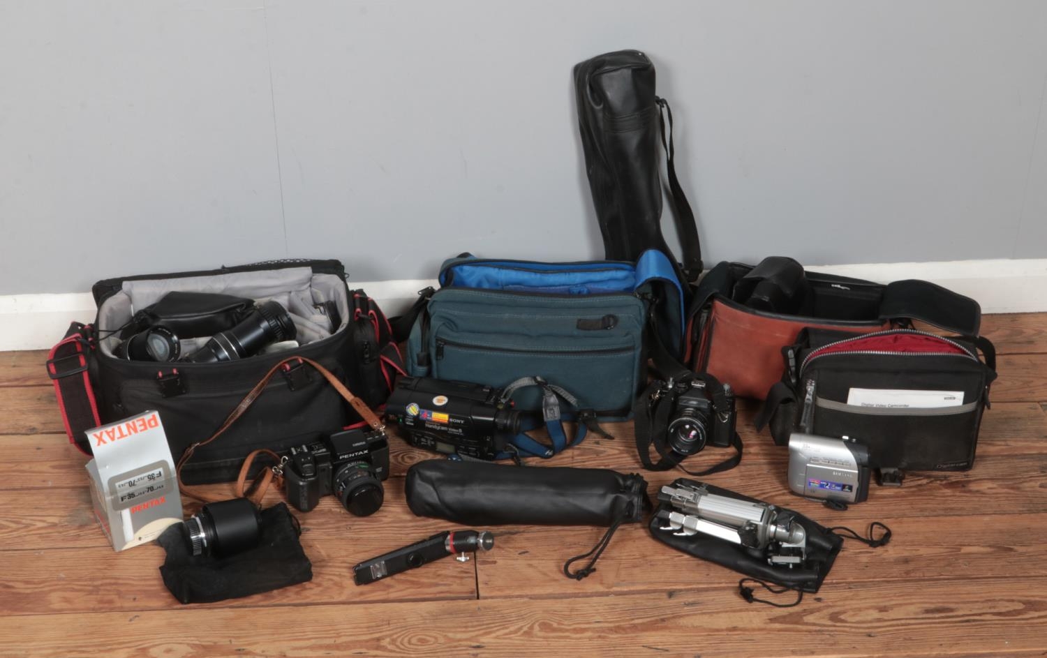 A collection of assorted cameras and accessories to include Pentax SFX, Sony Handycam Video 8, Zenit