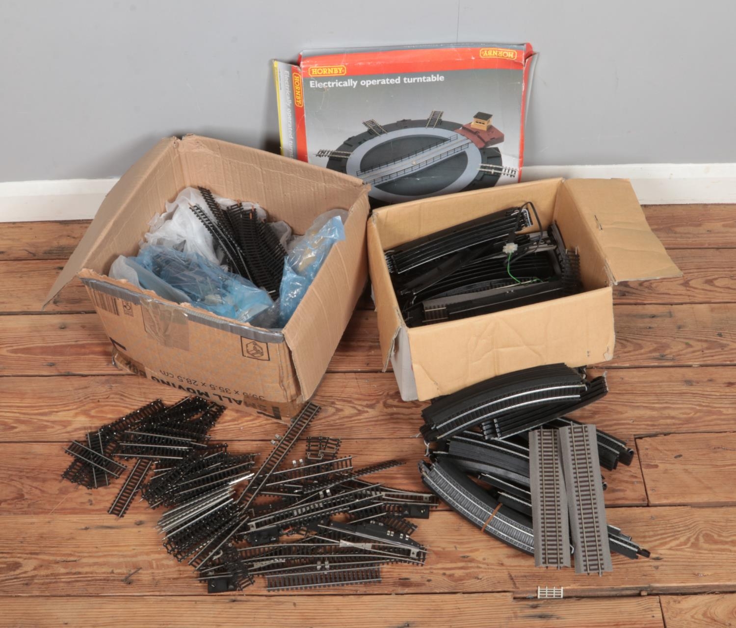 Two boxes full of 00 gauge track including a Hornby electrically operated turntable.