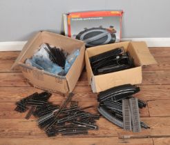 Two boxes full of 00 gauge track including a Hornby electrically operated turntable.