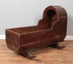 A Victorian mahogany and pine rocking crib. Height 74.5cm, Length 100cm. Signs of woodworm.