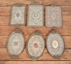 A collection of six vanity trays with lace under glass with brass detail surround.