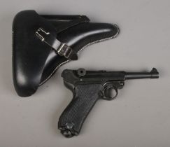 A replica Denix P-08 Parabellum pistol, in reproduction holster, stamped P08, 1941. Pistol stamped