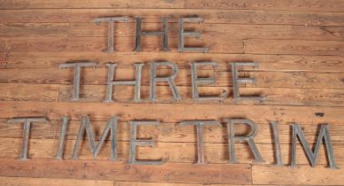 A large quantity of bronze letters potentially used outside of a pub or shop. 16 letters in total.