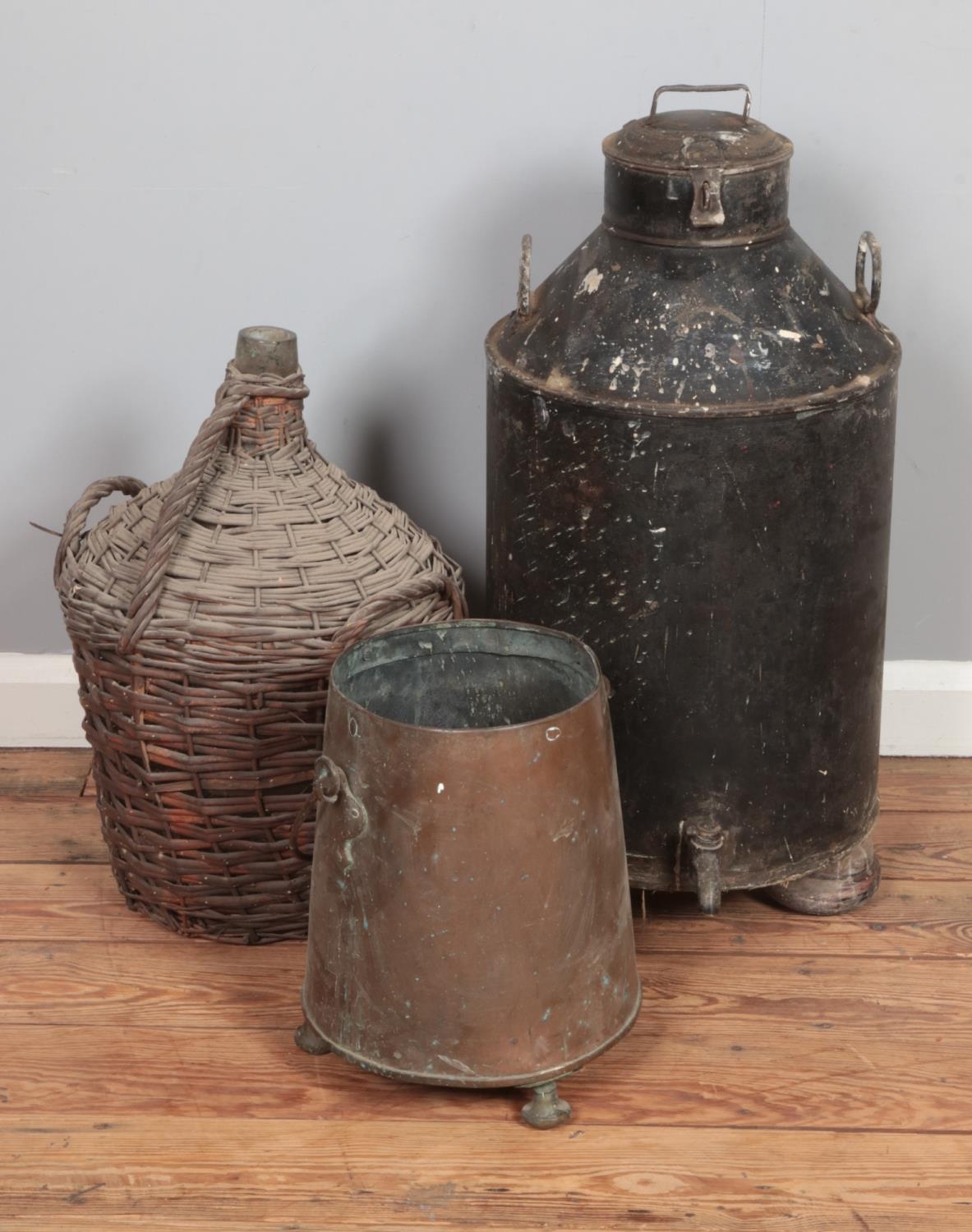 A large milk churn together with wicker clad demijohn and copper log/coal bucket