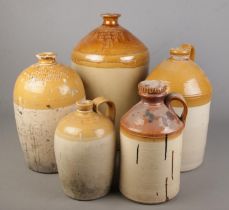 Five large stoneware flagons. Includes tallest marked for Bentley & Son, Doncaster (49cm), J&G
