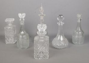 Six cut and pressed glass decanters. Replacement tops to some examples.