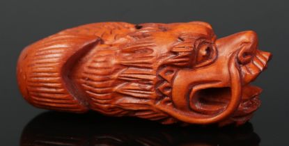 A hand carved hardwood netsuke of a dragon fish. Signed.