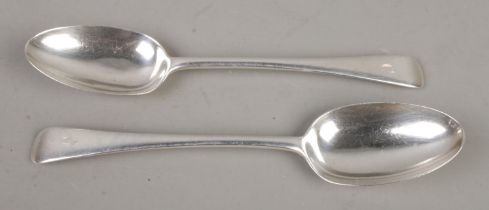 A pair of Edwardian silver basting spoons, with 'C' stenciled to the top of the handle. Assayed