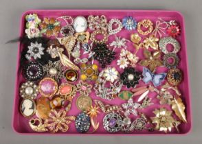 A tray containing a very large collection of costume jewellery, mainly brooches. To include