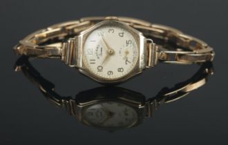 A ladies 9ct Gold Rotary Seven manual wind wristwatch, on 9ct Gold Britannic watch strap. Total