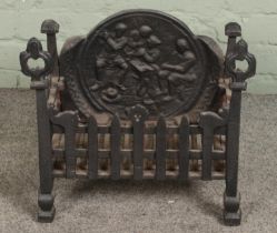 A small cast iron fire grate with decorative back plate Hx43cm Wx47cm Dx27cm