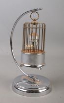 A novelty clock formed as a bird cage suspended on stand. Height 21cm.