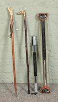 Two walking sticks including bone handled example along with two vintage chest expanders.