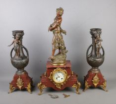 A three-piece Auguste Moreau spelter and marble clock garniture featuring central maiden figure