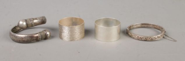 A collection of silver oddments, to include hinged bangle and two napkin rings. Total weight: 79.6g.