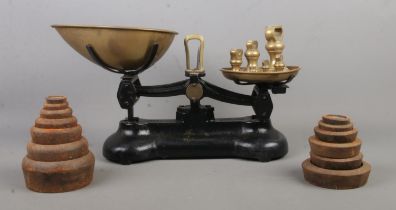 A set of Libra weighing scales, with seven brass weights, accompanied by two near complete sets of