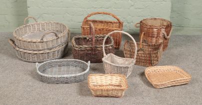 A large collection of wicker baskets and trays, to include small log basket, flower/potato and