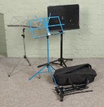 A selection of four adjustable music stands.