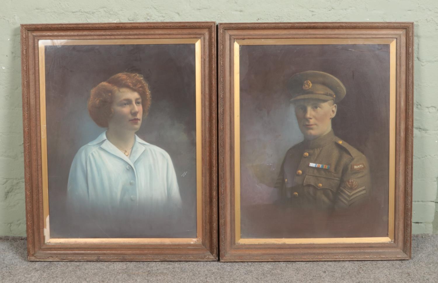 A pair of large framed overpainted photographs, depicting a soldier and a maiden. 65cm x 51cm.