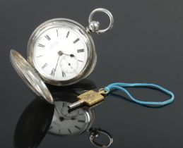 A silver cased full hunter pocket watch, having engine turned case, enamel dial with subsidiary