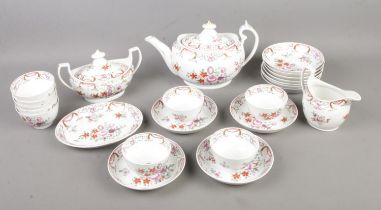 An early 19th century hand painted tea service featuring floral design and gilt detail. Includes tea