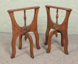 A pair of carved oak trestles. Having swivel supports. Height 63cm.