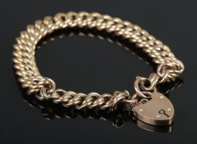 A 9ct Gold rope twist bracelet chain with heart shaped locket clasp. The locked monogrammed for KAH.