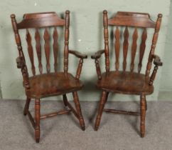 A pair of wooden slat back chairs.