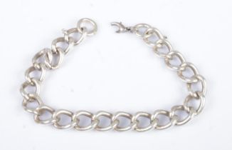 A silver curb bracelet. Approximate length 20cm. 39g. Clasp broken. No stamp, tests as silver.