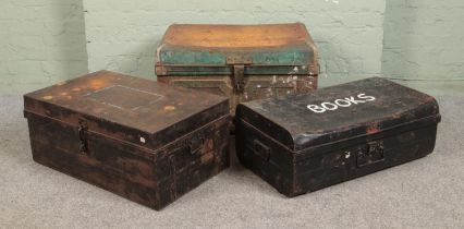 Three hinged top tin trunks; Largest - Height: 44cm, Width: 74cm, Depth: 39cm.