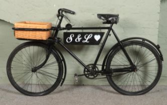 A black painted Butchers 'Tradesman' bike, with wraparound metal fame to the front housing a