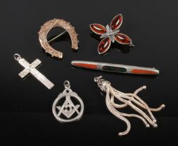 A small collection of white metal jewellery including silver cross pendant and silver brooch.