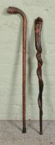 Two hardwood walking sticks, including one carved example formed as a cobra twisted around a cane.