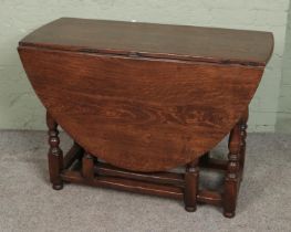 A Georgian style oak drop leaf gate leg table.