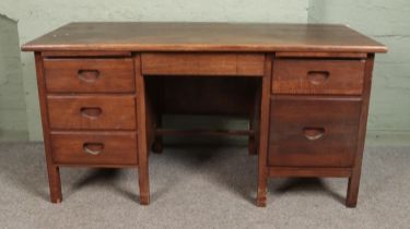 A mid 20th century oak double pedestal desk with recessed drawer handles Hx76cm Wx152cm Dx76cm