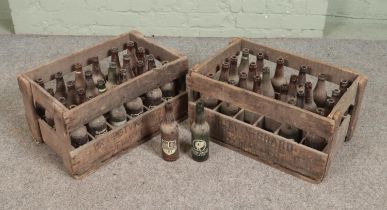 Two vintage wooden Potvin Grard crates with contents of empty bottles. Bottles include Potvin