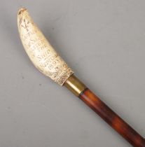 A bamboo walking cane with faux scrimshaw pommel carved for Captain Robert Shaw, Master Of The