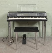 A Wurlitzer 200A Electronic Piano, with foot pedal, volume and vibrato dials. Accompanied by a paino